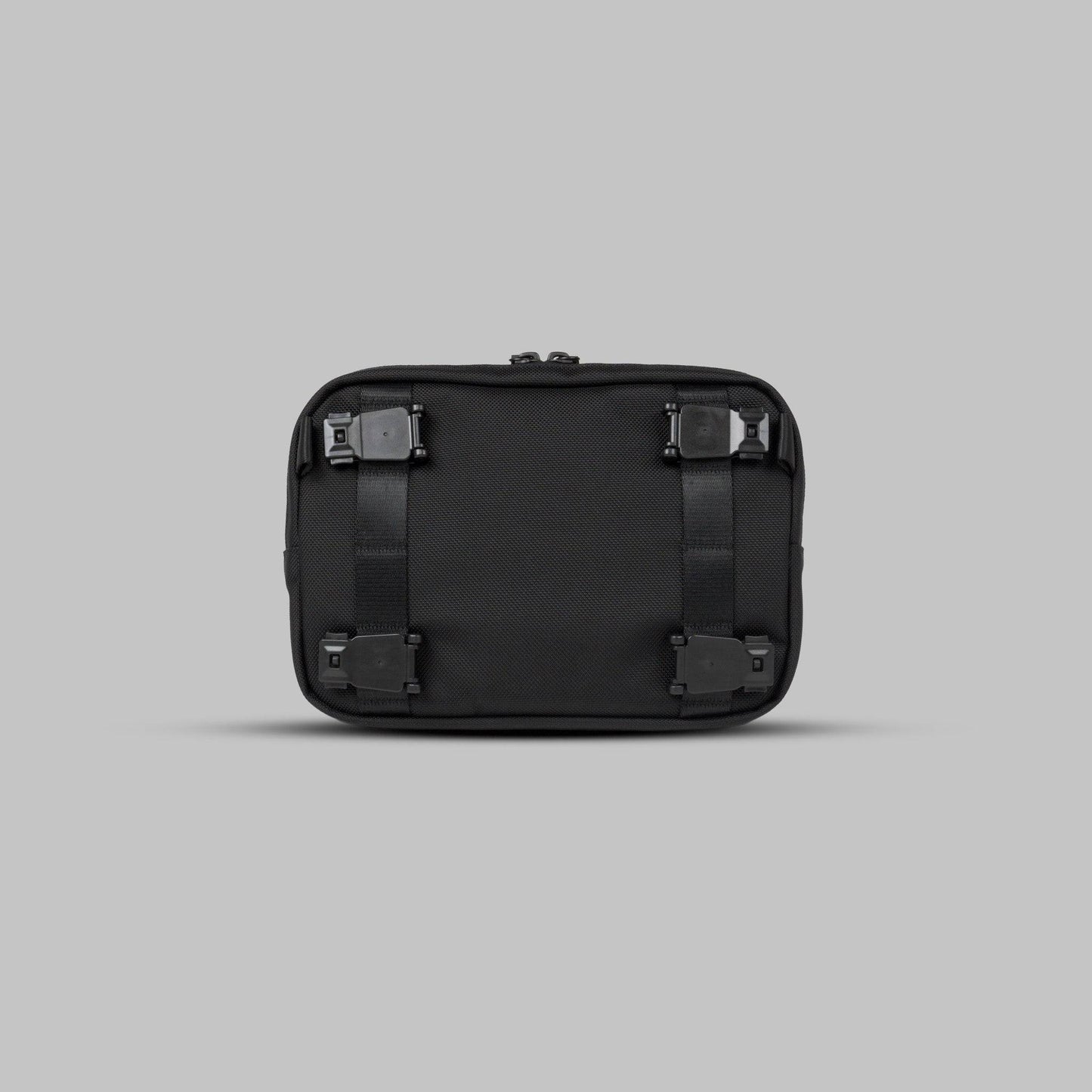 Back view of the Rework Gear Essentials Case against a gray background.