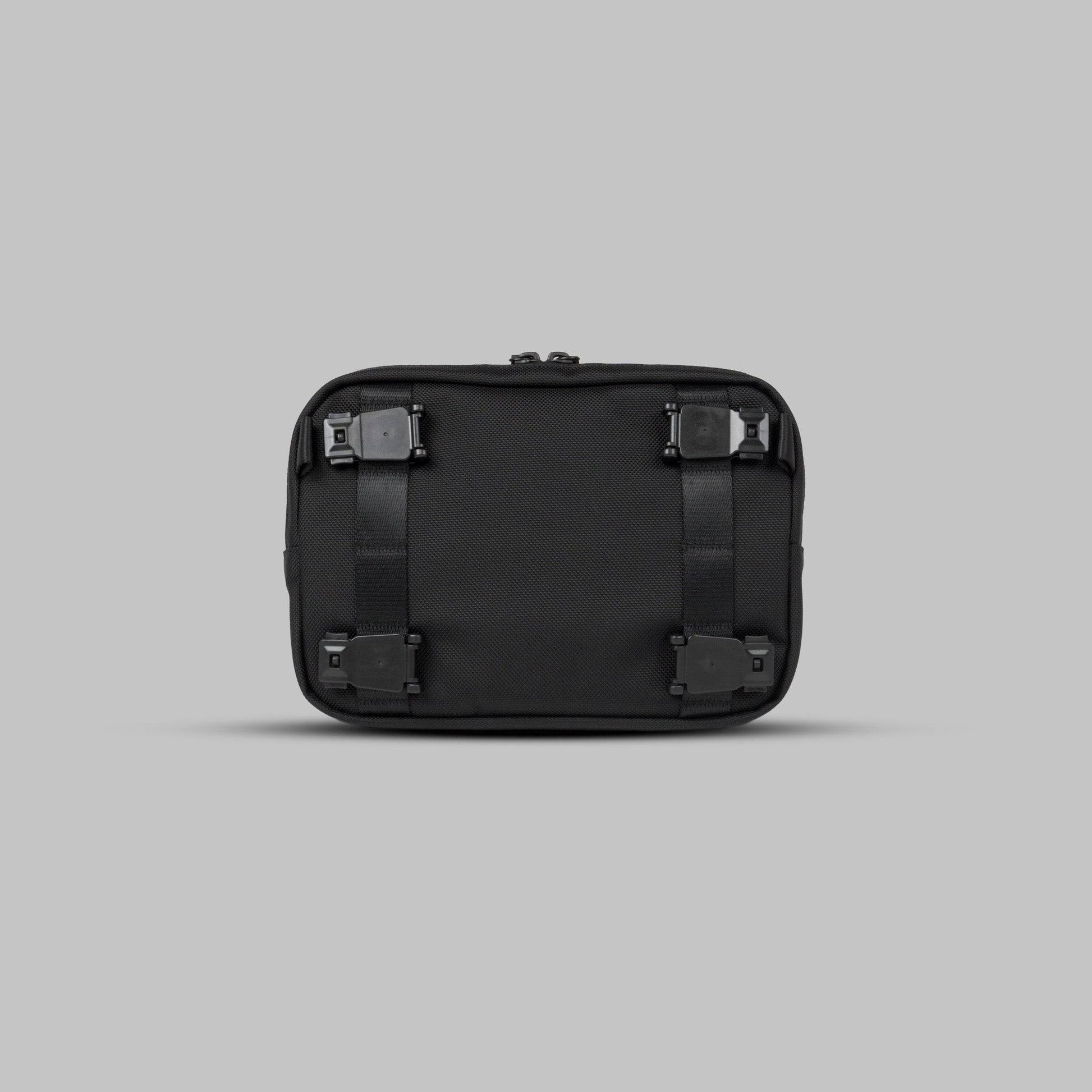 Back view of the Rework Gear Essentials Case against a gray background.