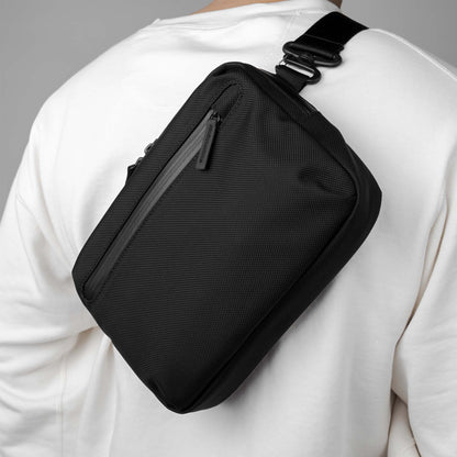 A man wearing the Rework Gear Essentials Case  as a sling.