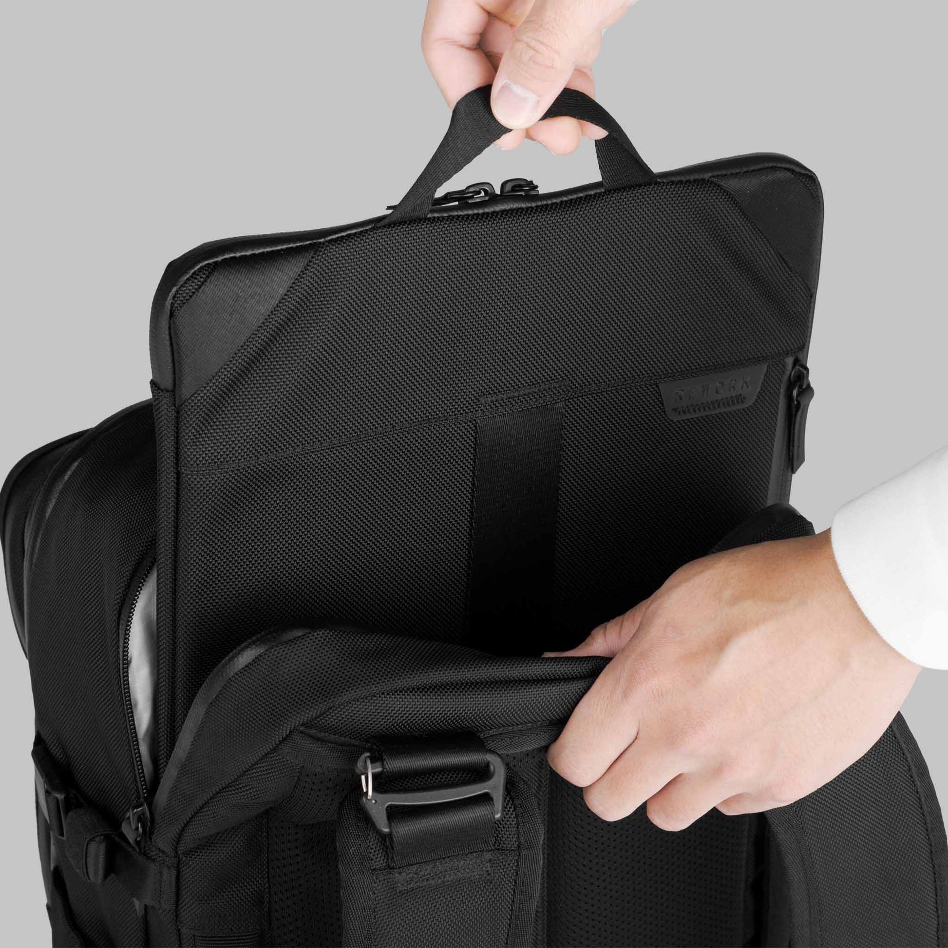 Person pulling a laptop case out of the laptop compartment of a modular backpack by Rework Gear.