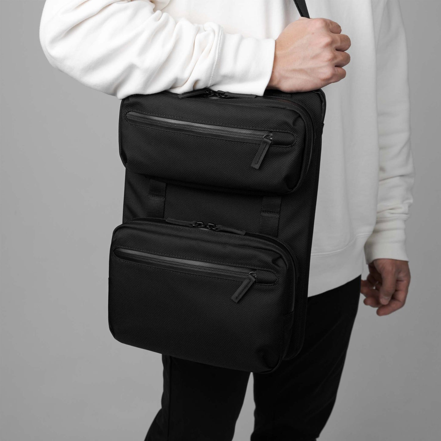 Man carrying the Rework Gear laptop Case as a sling.