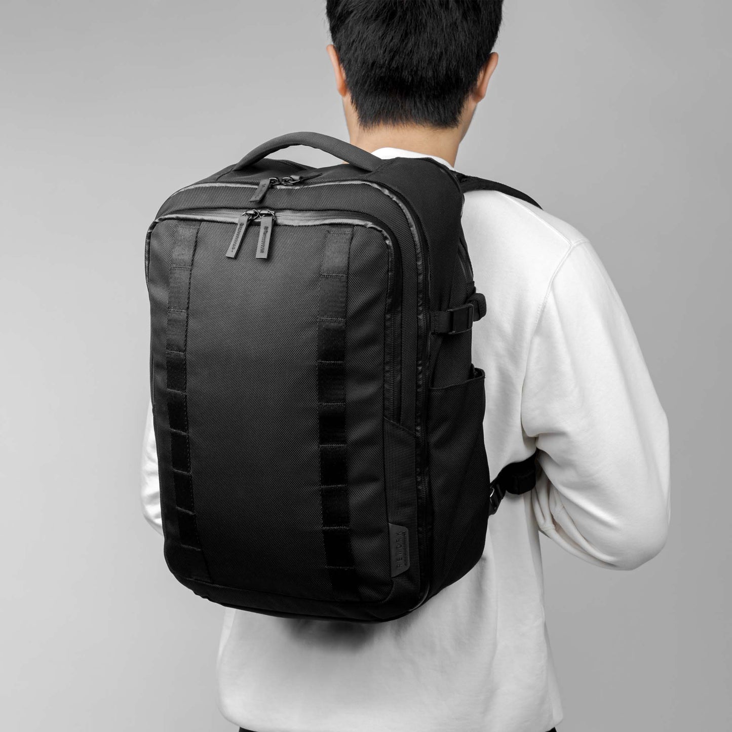 Back view of a model carrying the 22L Reset Pack by Rework Gear.