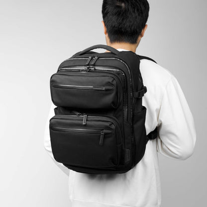 Back view of a model carrying a modular backpack called the Reset System by Rework Gear.