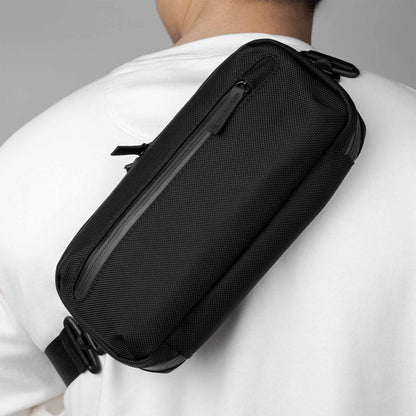 Man wearing the Rework Gear Tech Case as a sling.